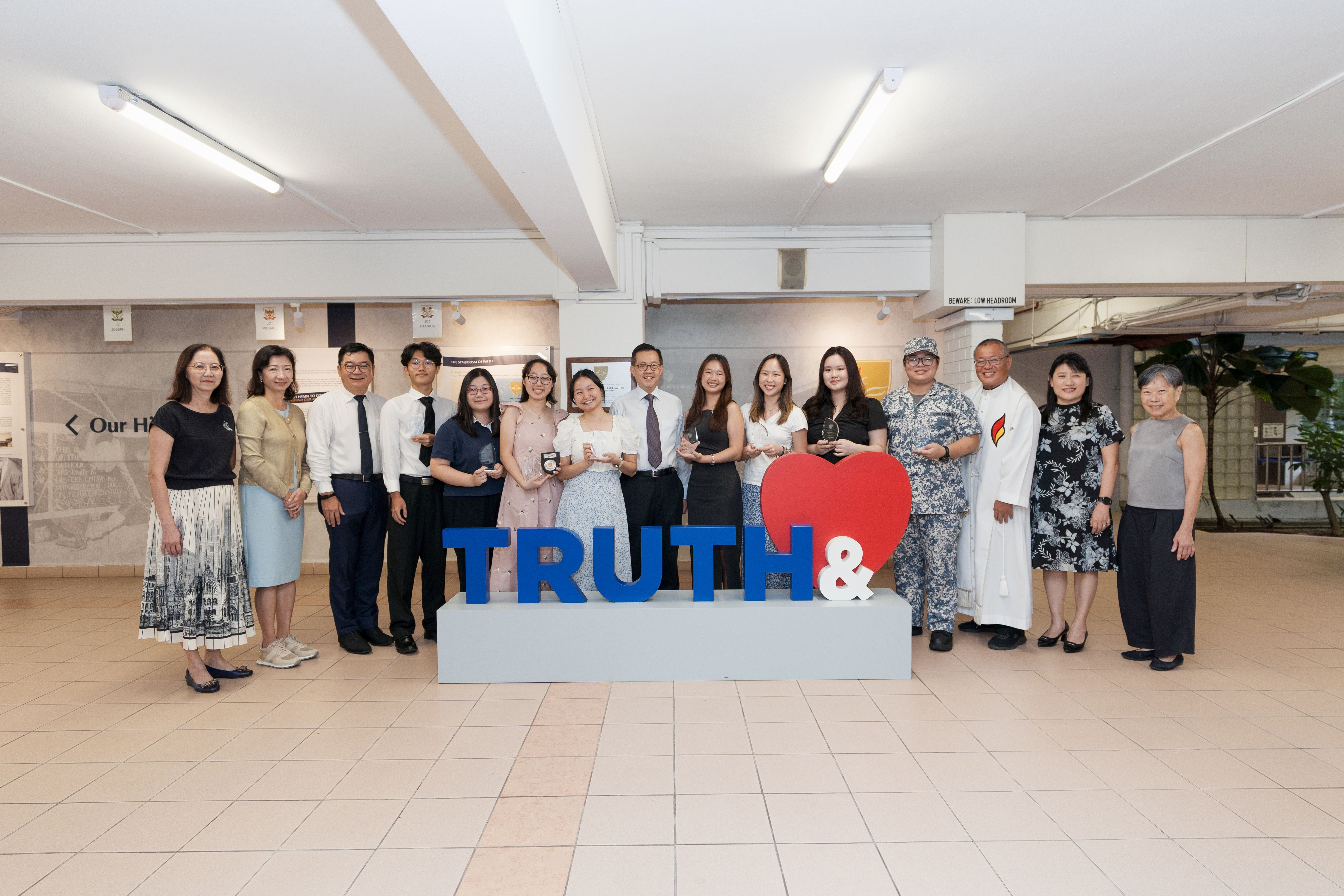 Special award winners with Mr Leo Yip, School Leaders, and College Chaplain at Love and Truth sculpture